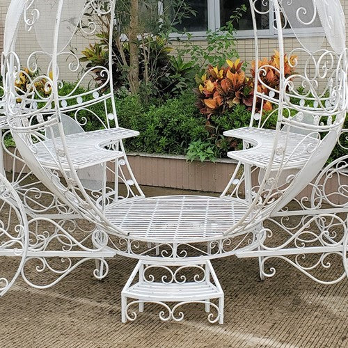 White egg shaped carriage bench and plant stand with lanterns