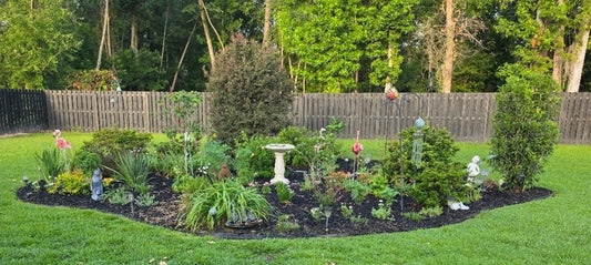 a garden with birdbath and other garden decor