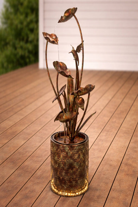 Decorative metal plant sculpture on a wooden deck