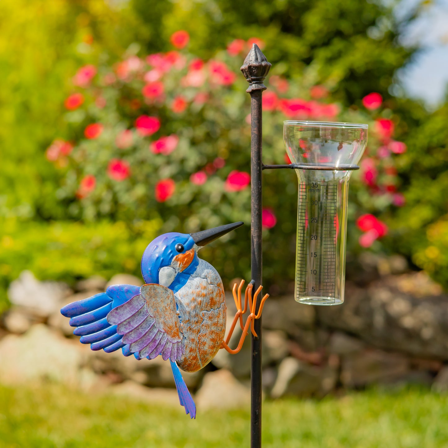 Decorative bird-shaped solar water fountain with a blurred garden background