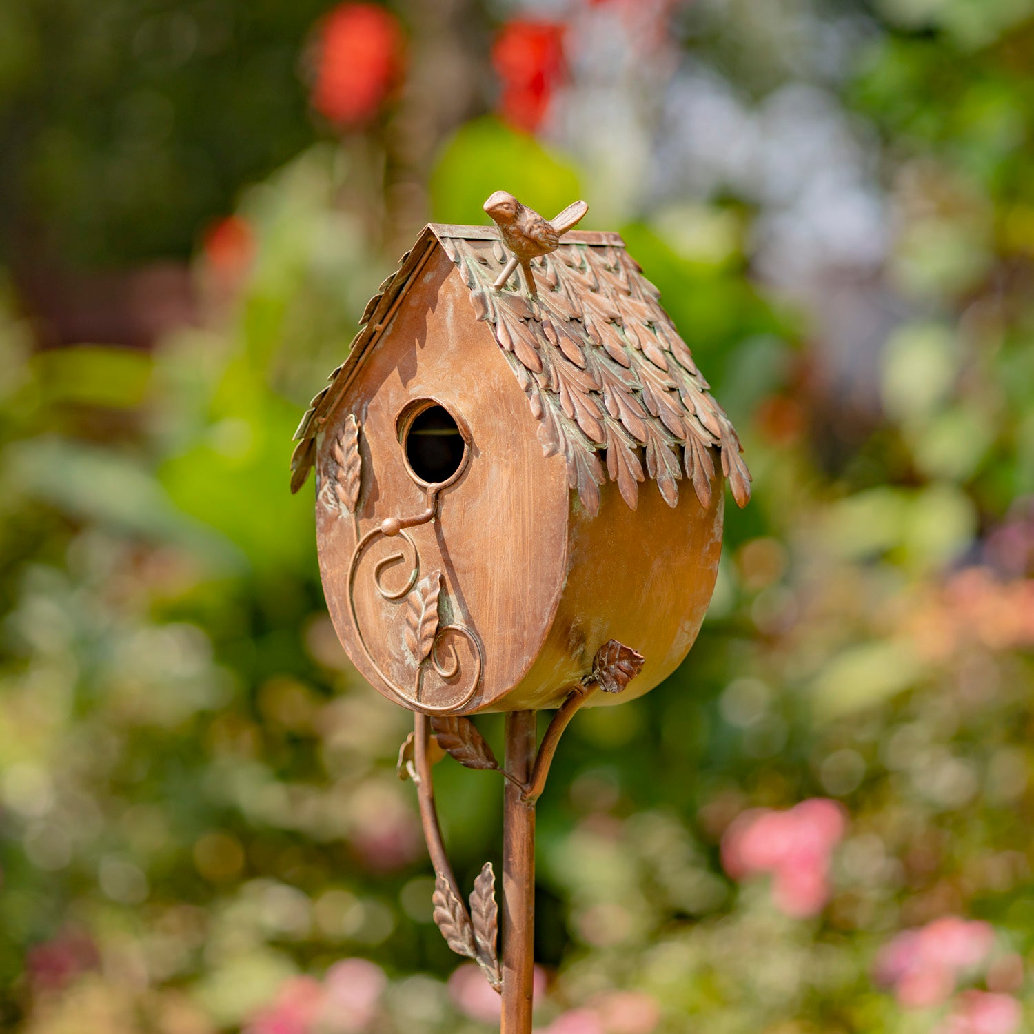 Wooden birdhouse with decorative elements on a blurred natural background
