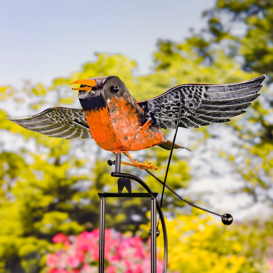 Decorative metal bird sculpture with a blurred natural background