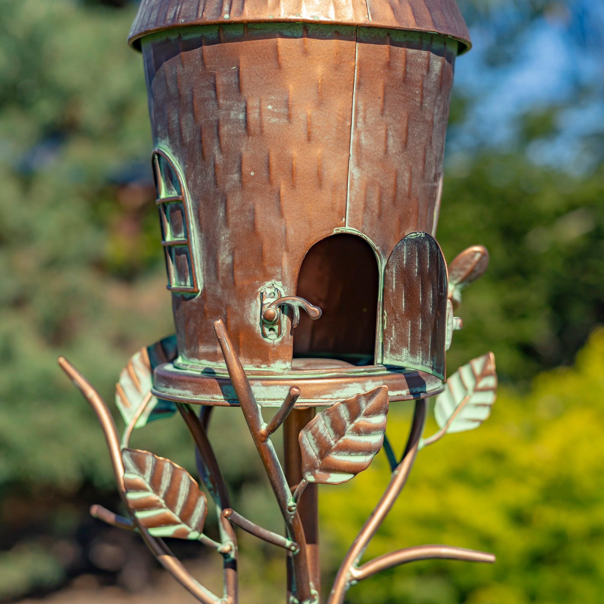 Decorative birdhouse with a rustic design on a blurred natural background