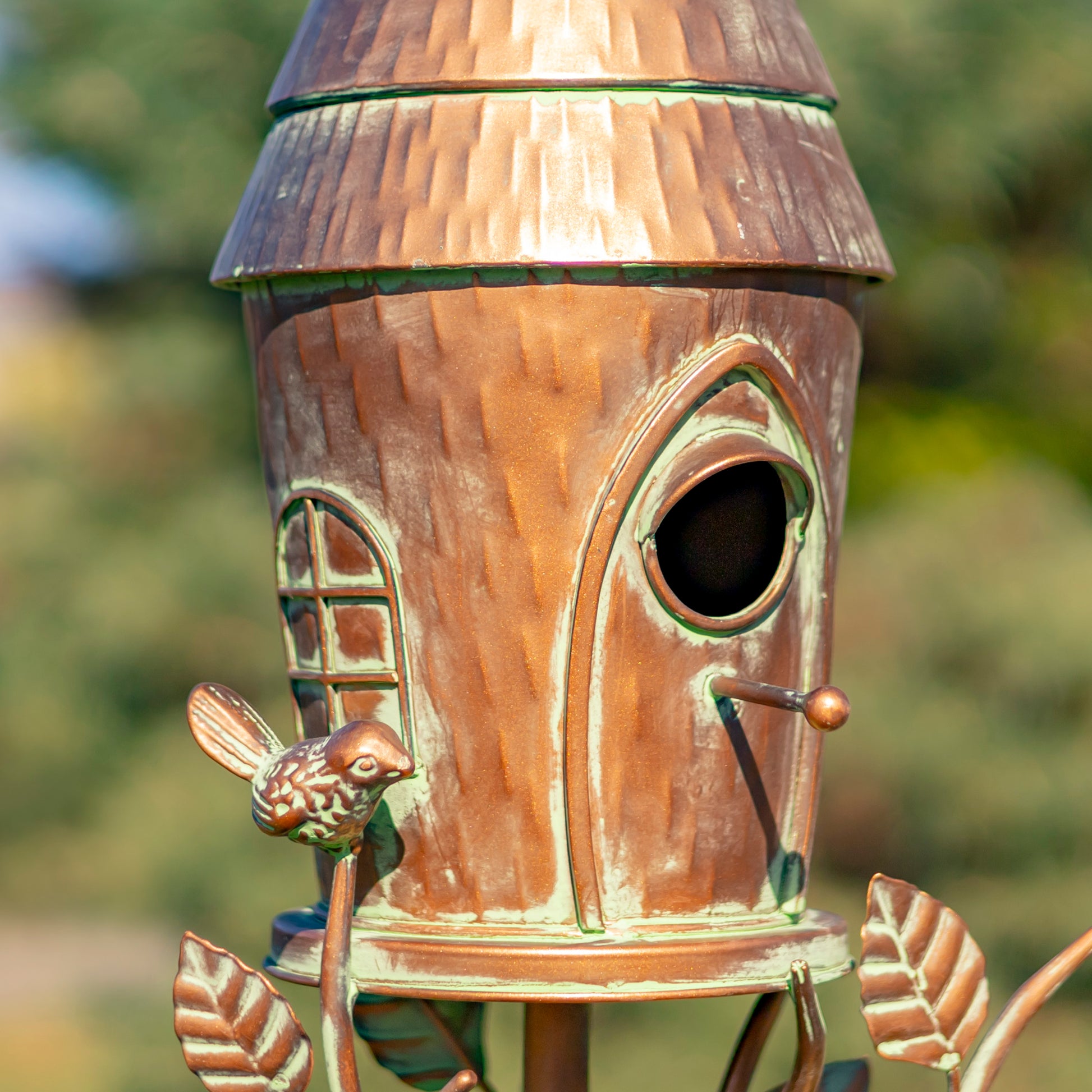 Wooden birdhouse with a rustic finish against a blurred natural background