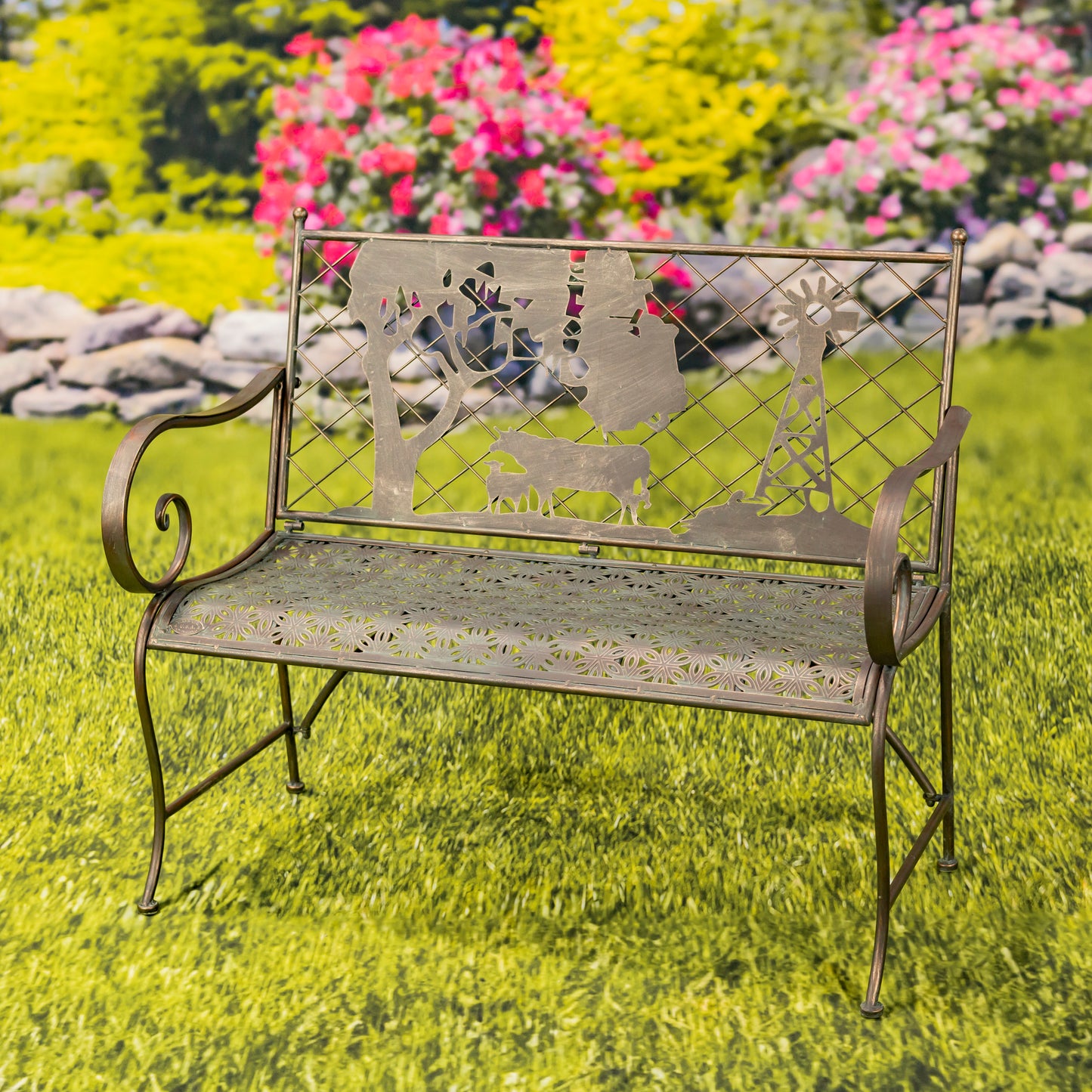 Decorative metal bench with animal cutouts on a grassy area with flowers in the background
