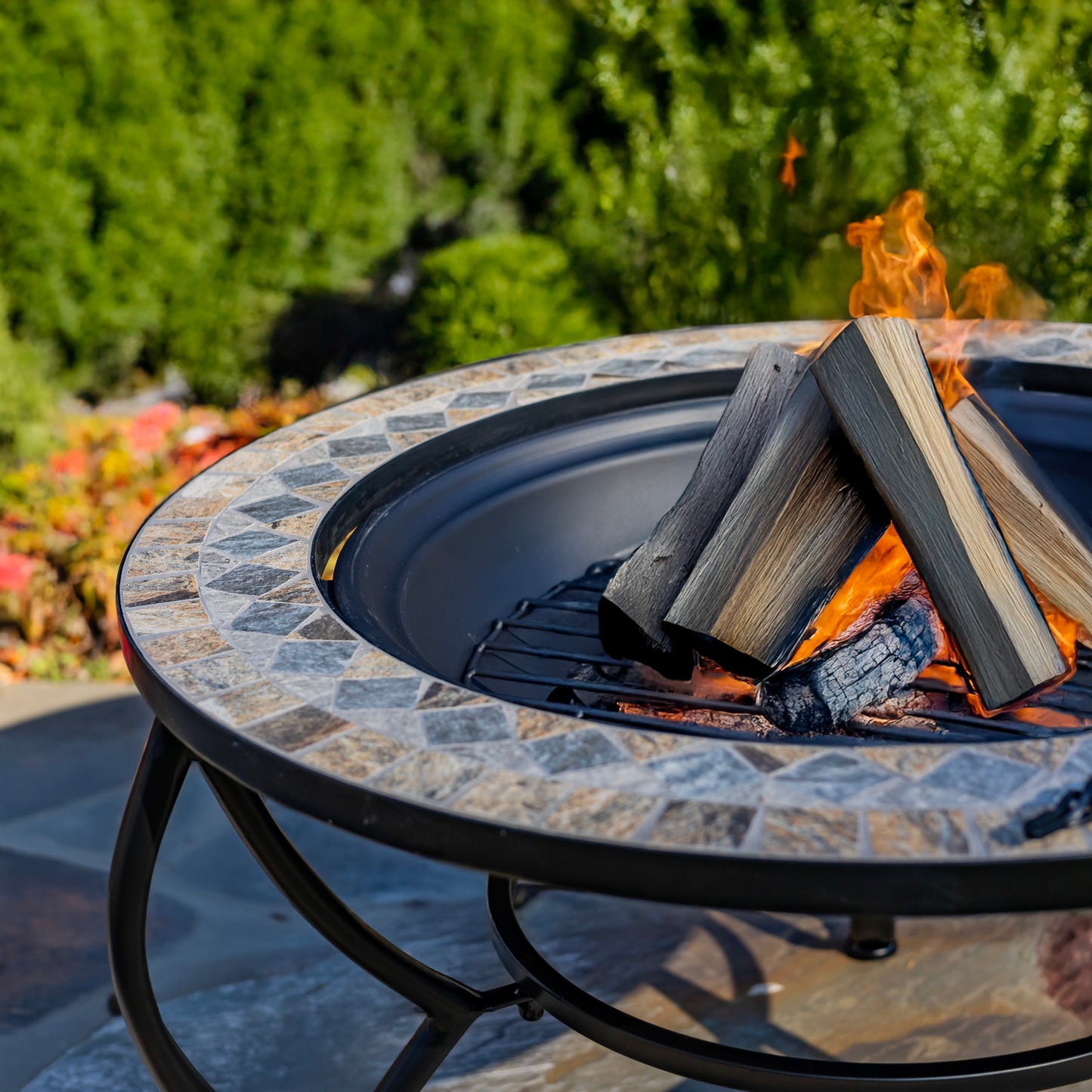 Fire pit with burning wood and flames in an outdoor setting