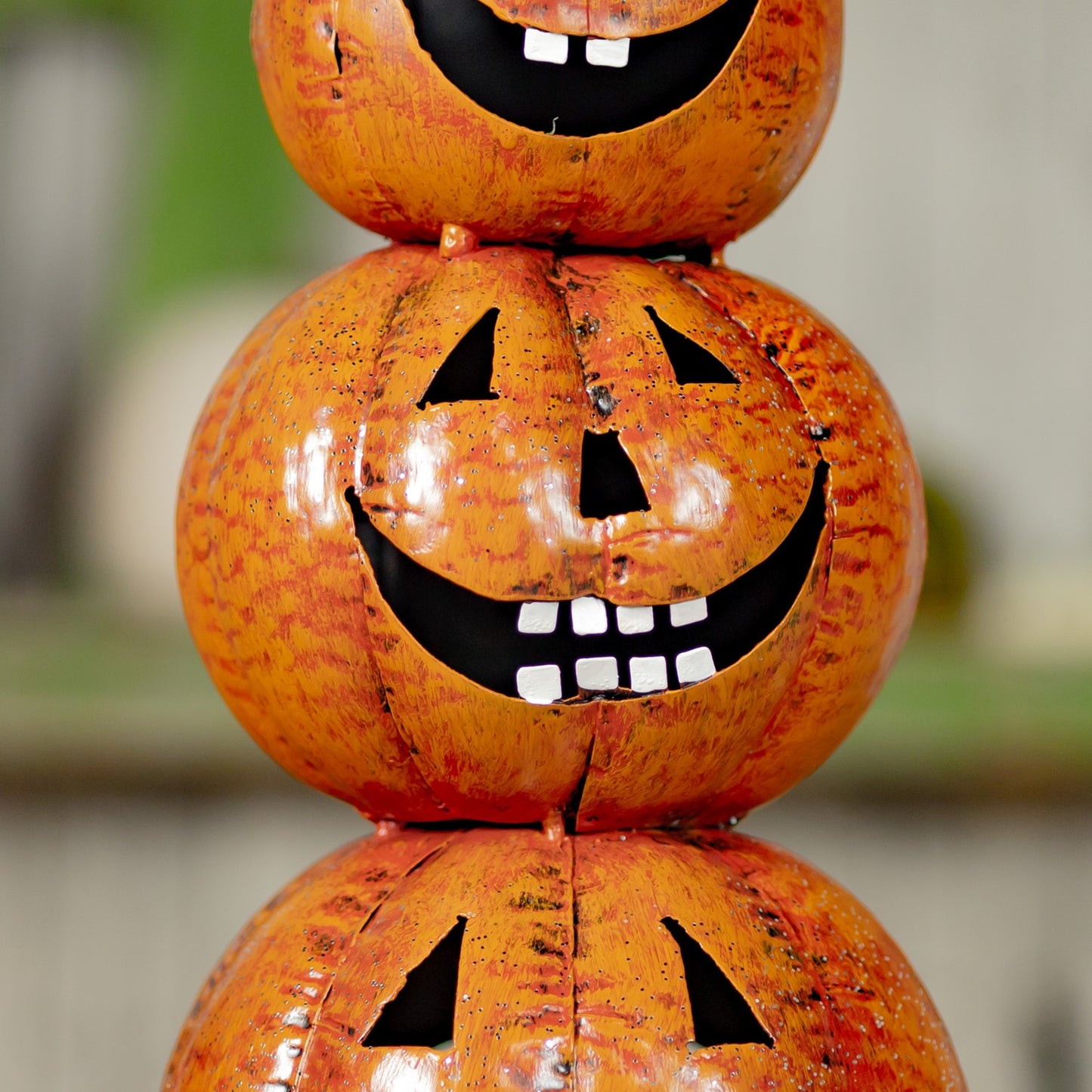Middle  carved pumpkin with a happy  face showing 8 teeth