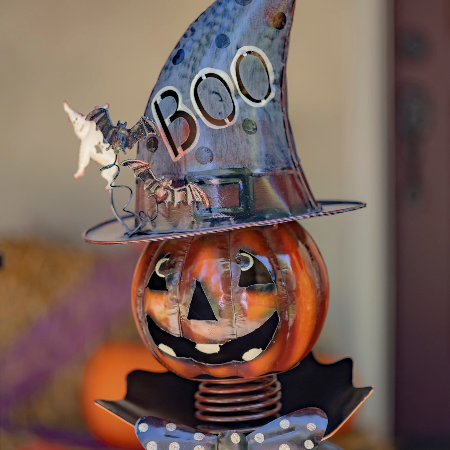 Halloween-themed decoration with a jack-o'-lantern face, ghost, and 'BOO' hat.