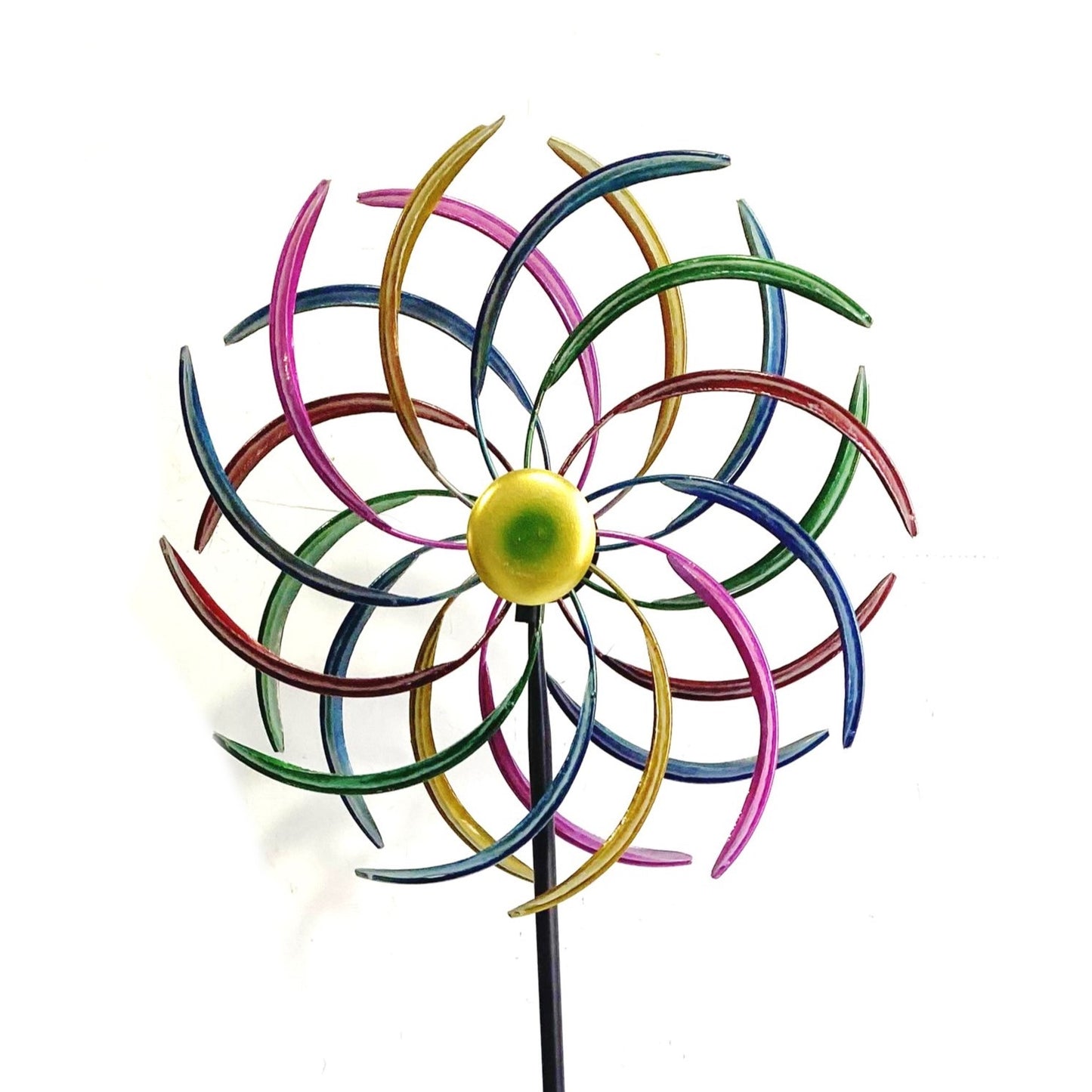 A colorful metal pinwheel garden stake with curved rainbow-colored blades and a yellow-green center, mounted on a black stake against a plain white background.