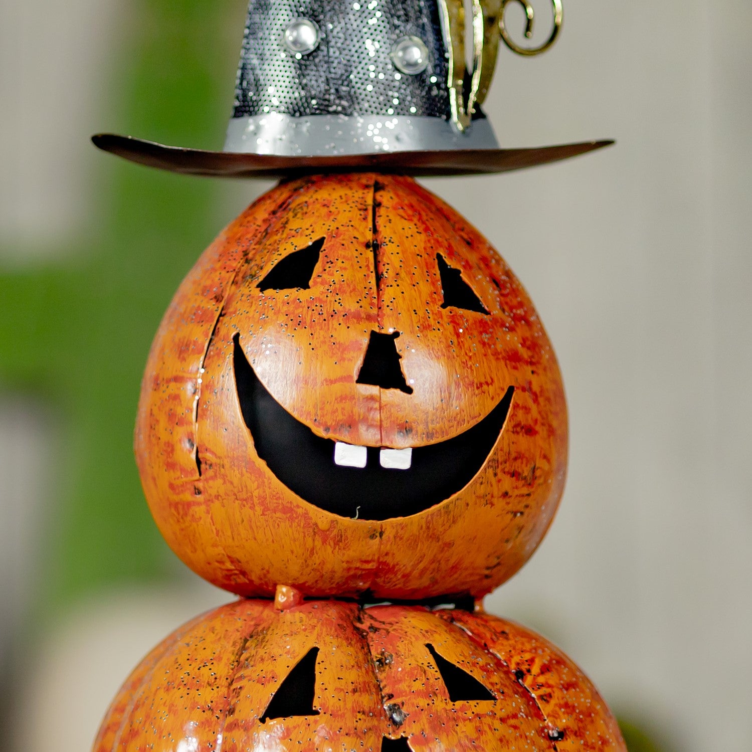 Top carved pumpkin with a happy  face showing 2 teeth