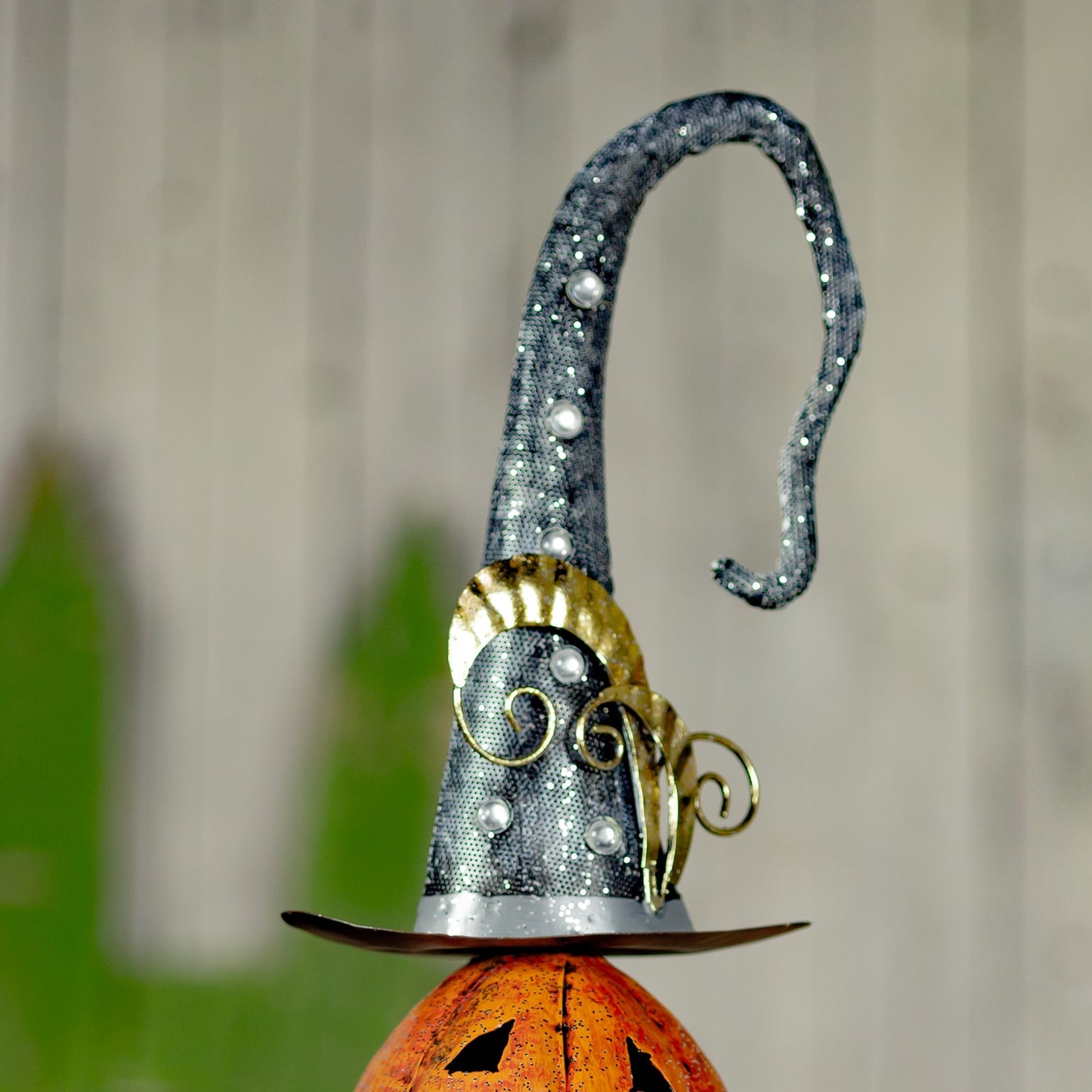 Top of pumpkin stack showing sparkly witches hat with gold feathers