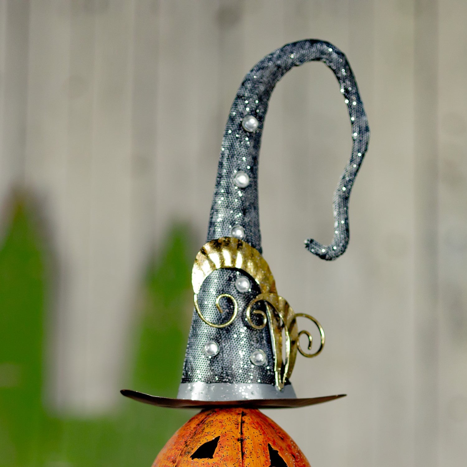 Top of pumpkin stack showing sparkly witches hat with gold feathers