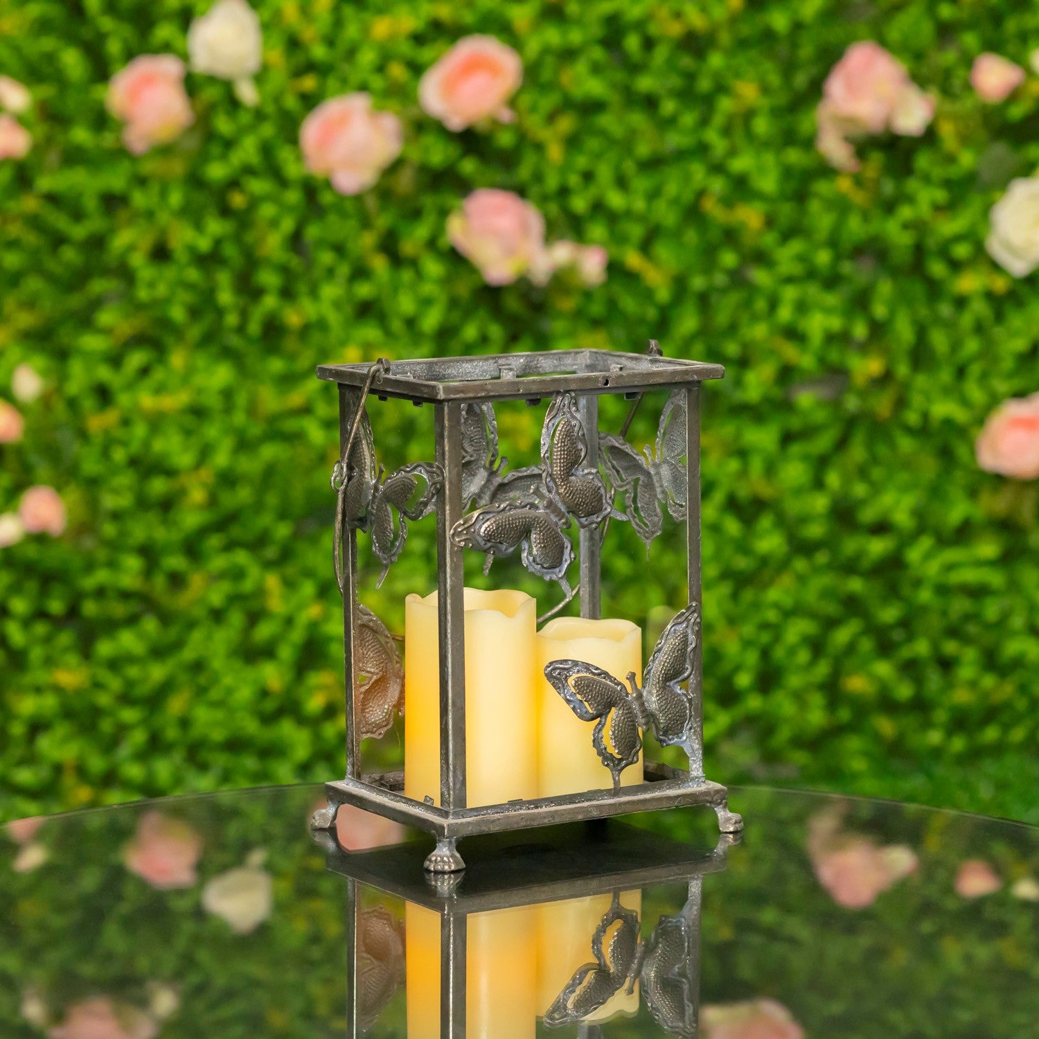 Decorative lantern with butterflies holding candles against a floral background