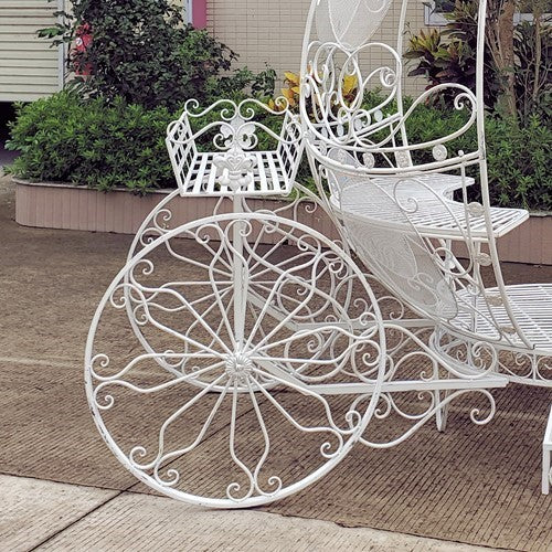 White egg shaped carriage bench and plant stand with lanterns
