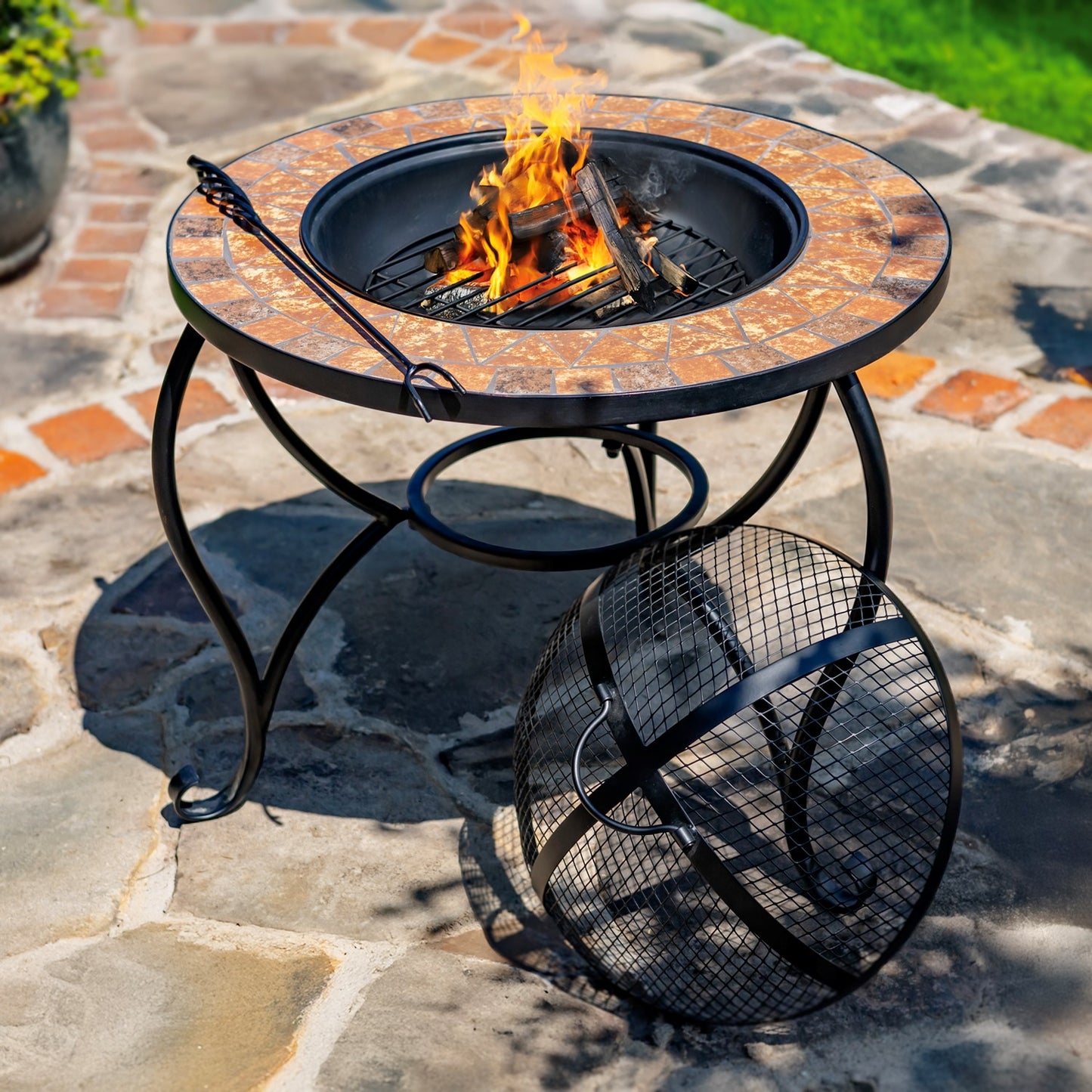 Outdoor fire pit table with flames on a stone patio