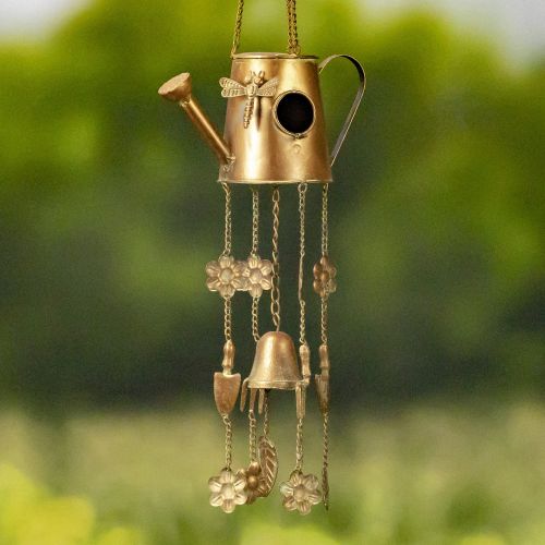 Decorative wind chime shaped like a watering can with hanging charms against a green background