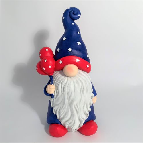 Gnome figurine with a blue hat and red outfit holding balloons on a white background